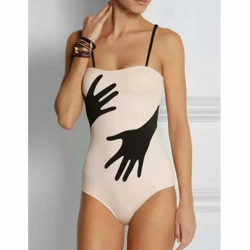 Women's one-piece bikini swimsuit with gauze skirt detail on beach