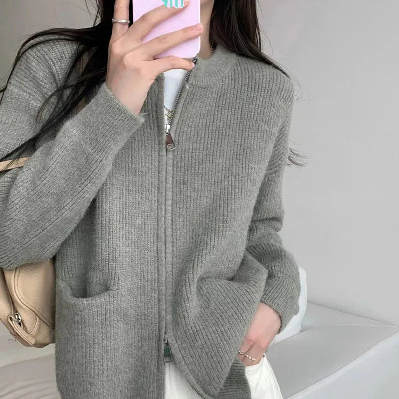 Beige women's long sleeve soft glutinous sweater coat cardigan laid flat.