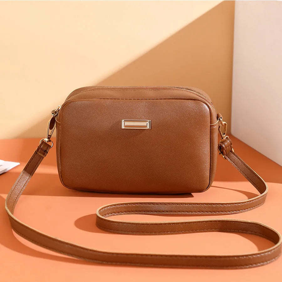 Solid colour PU women's shoulder bag showing three-dimensional pocket, in horizontal square shape.